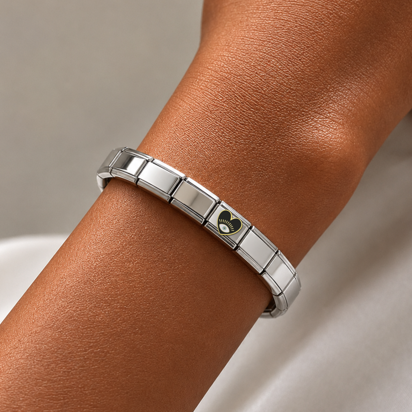 Black Blue-Eyed Heart – silver Italian charm worn on an Italian charm bracelet
