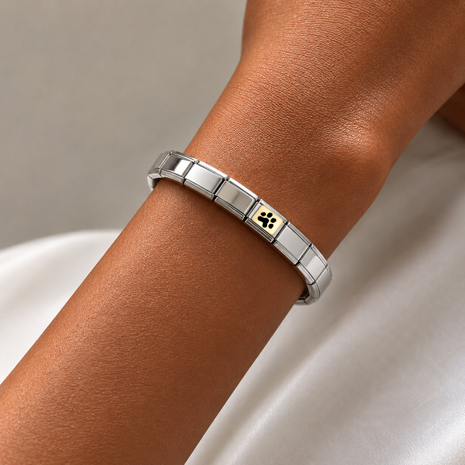 Tiny Paw Print – silver Italian charm worn on an Italian charm bracelet