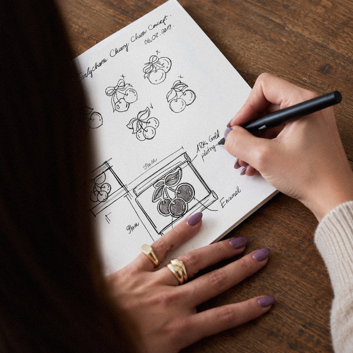Hand sketch of a cherry charm in the Italycharm studio notebook